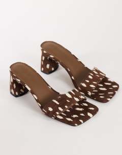 Model wearing Nela mid heel mule in brown deer print hair on real leather