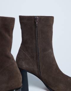 Model wearing Nellie suede heeled ankle boot in chocolate