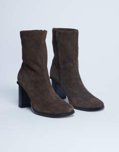 Model wearing Nellie suede heeled ankle boot in chocolate
