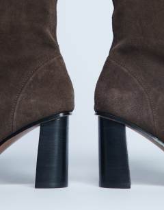 Model wearing Nellie suede heeled ankle boot in chocolate