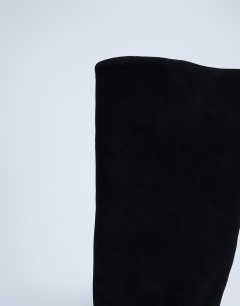 Model wearing Nelly real suede pointed toe slouch boot in black