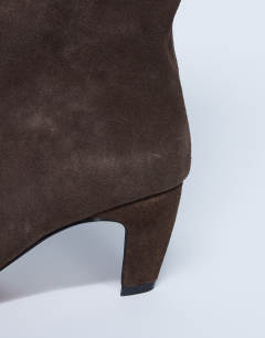 Model wearing Nelly real suede pointed toe slouch boot in chocolate