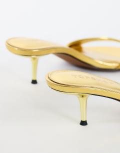 Model wearing Neptune kitten heel mule in gold
