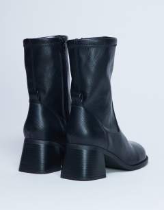Model wearing Niamh block heel ankle boot in black