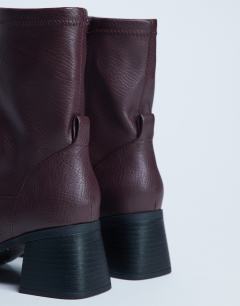 Model wearing Niamh block heel ankle boot in burgundy