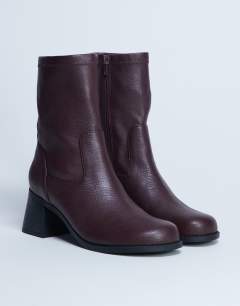 Model wearing Niamh block heel ankle boot in burgundy