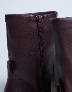 Model wearing Niamh block heel ankle boot in burgundy