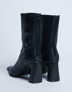 Model wearing Nicky chisel toe ankle boot in black