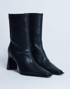 Model wearing Nicky chisel toe ankle boot in black