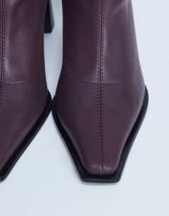 Model wearing Nicky chisel toe ankle boot in burgundy