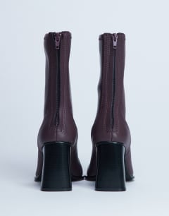 Model wearing Nicky chisel toe ankle boot in burgundy