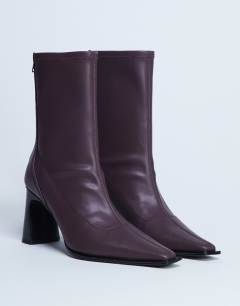 Model wearing Nicky chisel toe ankle boot in burgundy