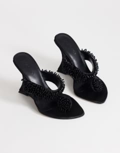 Model wearing Nico wedge mule with embellishment in black 