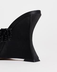 Model wearing Nico wedge mule with embellishment in black 