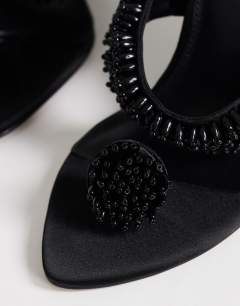 Model wearing Nico wedge mule with embellishment in black 