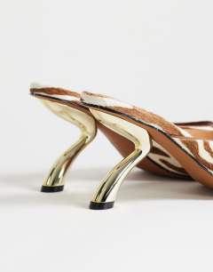 Model wearing Nicole angular mid heel mule in zebra print hair on real leather