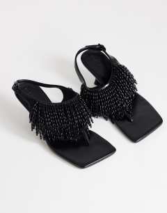 Model wearing Night beaded toe thong heeled sandal in black