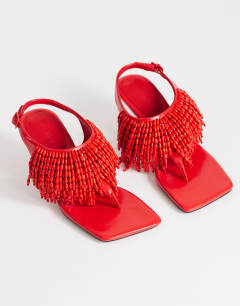 Model wearing Night beaded toe thong heeled sandal in red