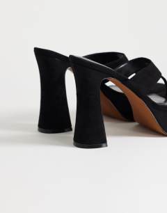 Model wearing Nima platform heeled toe thong sandal in black