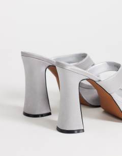 Model wearing Nima platform heeled toe thong sandal in grey satin