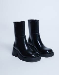 Model wearing Nina chunky heeled ankle boot in black