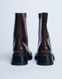 Model wearing Nina chunky heeled ankle boot in chocolate