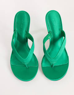 Model wearing Nina toe thong heeled sandal in green satin