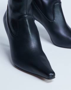 Model wearing Noah point toe boot in black