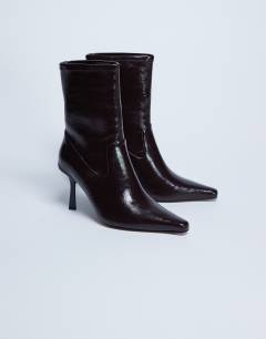 Model wearing Noah point toe boot in chocolate
