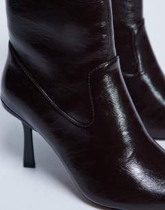 Model wearing Noah point toe boot in chocolate