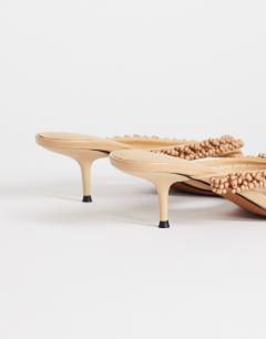 Model wearing Nolan beaded toe thong mid heel sandal in camel