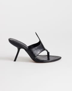 Model wearing Nora angular heeled mule sandal in black