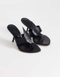 Model wearing Nora angular heeled mule sandal in black