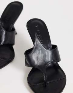 Model wearing Nora angular heeled mule sandal in black