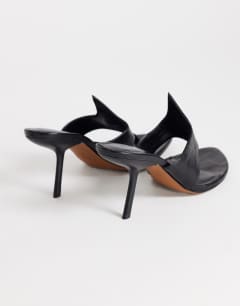 Model wearing Nora angular heeled mule sandal in black