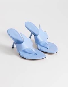 Model wearing Nora angular heeled mule sandal in cornflower blue