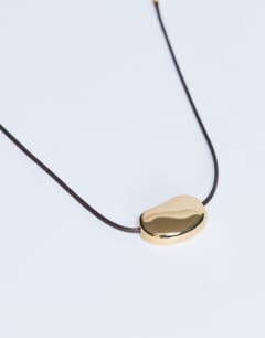 Model wearing Nora choker rope necklace with gem in gold