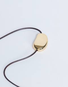 Model wearing Nora choker rope necklace with gem in gold