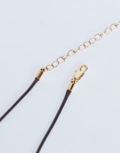 Model wearing Nora choker rope necklace with gem in gold