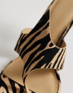 Model wearing Nora real leather with hair angular high heeled mule sandal in zebra