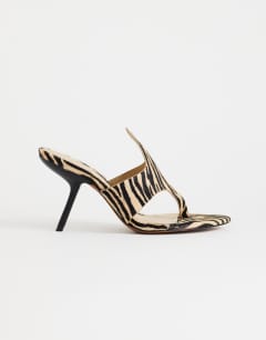 Model wearing Nora real leather with hair angular high heeled mule sandal in zebra