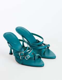 Model wearing Nori buckle detail heeled mule in teal