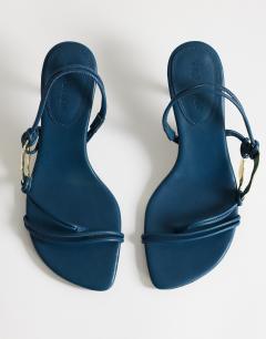 Model wearing Nova strappy mid heeled sandal with hardware in teal
