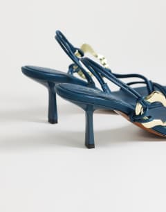 Model wearing Nova strappy mid heeled sandal with hardware in teal