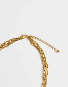 Model wearing Nyle stainless steel multi chain necklace with pendants in gold