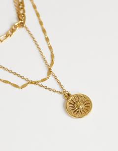 Model wearing Nyle stainless steel multi chain necklace with pendants in gold