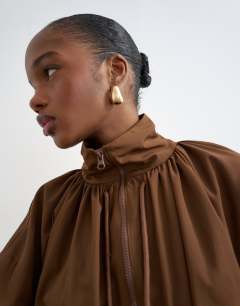 Model wearing Nylon anorak jacket in chocolate