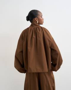 Model wearing Nylon anorak jacket in chocolate