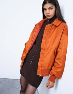 Model wearing Nylon bomber jacket in rust