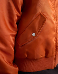 Model wearing Nylon bomber jacket in rust